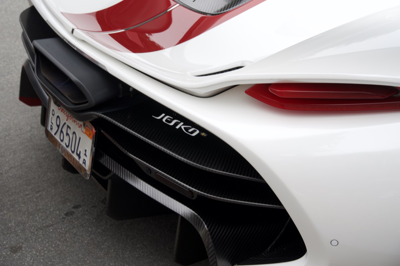 Close detail of the carbon-fibre rear diffuser and taillight of a white Koenigsegg Jesko